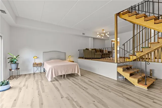 a spacious bedroom with a bed and a table