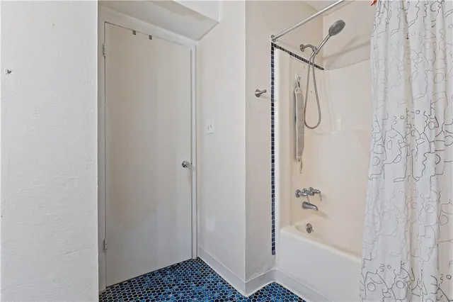 a bathroom with a bathtub and shower
