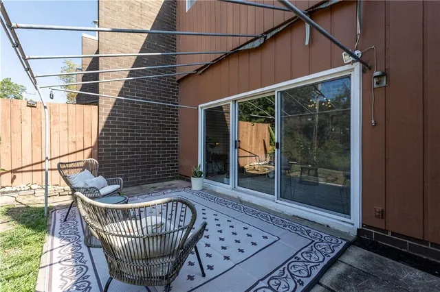 a porch with chair and glass door