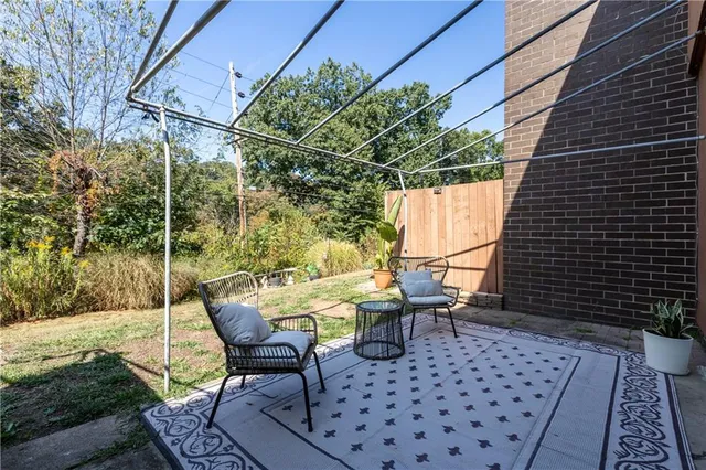 a view of a chairs and table in backyard
