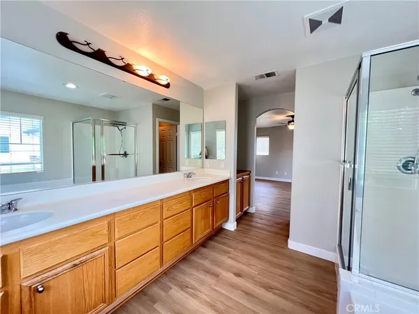 a large bathroom with a large mirror vanity and shower