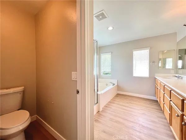 a bathroom with a granite countertop toilet a sink and a bathtub