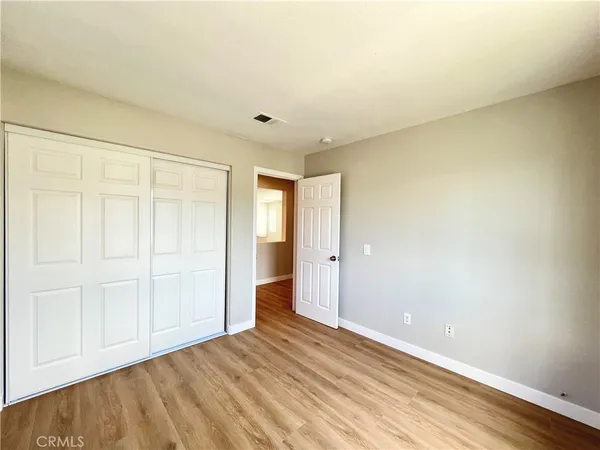 a view of an empty room and wooden floor