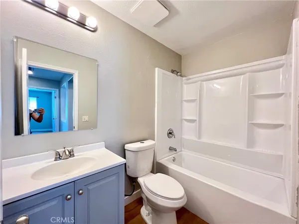 a bathroom with a sink toilet vanity and shower