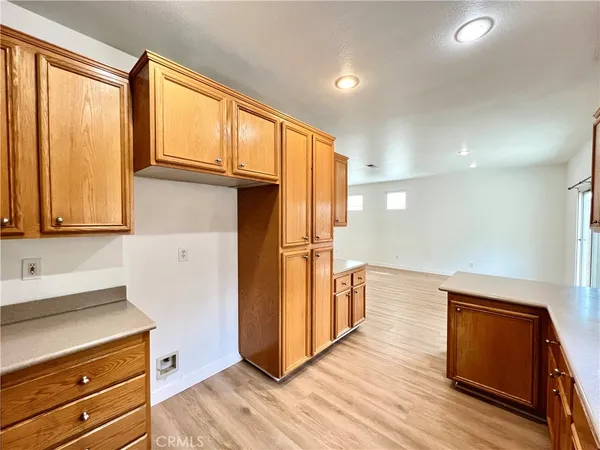 a kitchen with stainless steel appliances granite countertop a refrigerator a sink and wooden cabinets
