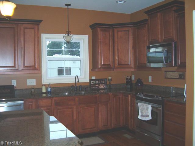 2756 Beckerdite Road Sophia, NC 27350 - Photo 2 of 6 Kitchen. kitchen has maple cabinets with accuride closures on drawers, granite countertops,cheery floors, stainless steel appliances,