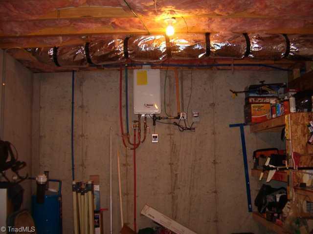 2756 Beckerdite Road Sophia, NC 27350 - Photo 3 of 6 Other. basement with tankless Rannai hot water heater, solid wall concrete construction ..