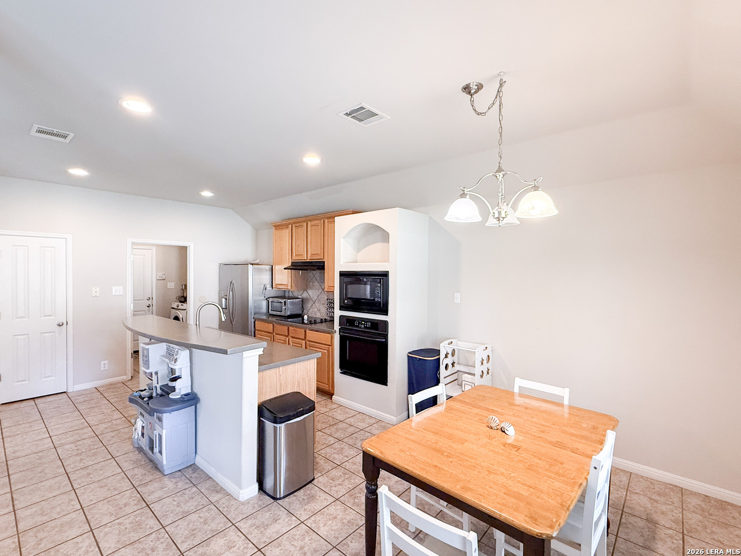 13715 Jubilee Way Helotes, TX 78023 - Photo 11 of 34 a kitchen with a table and chairs in it