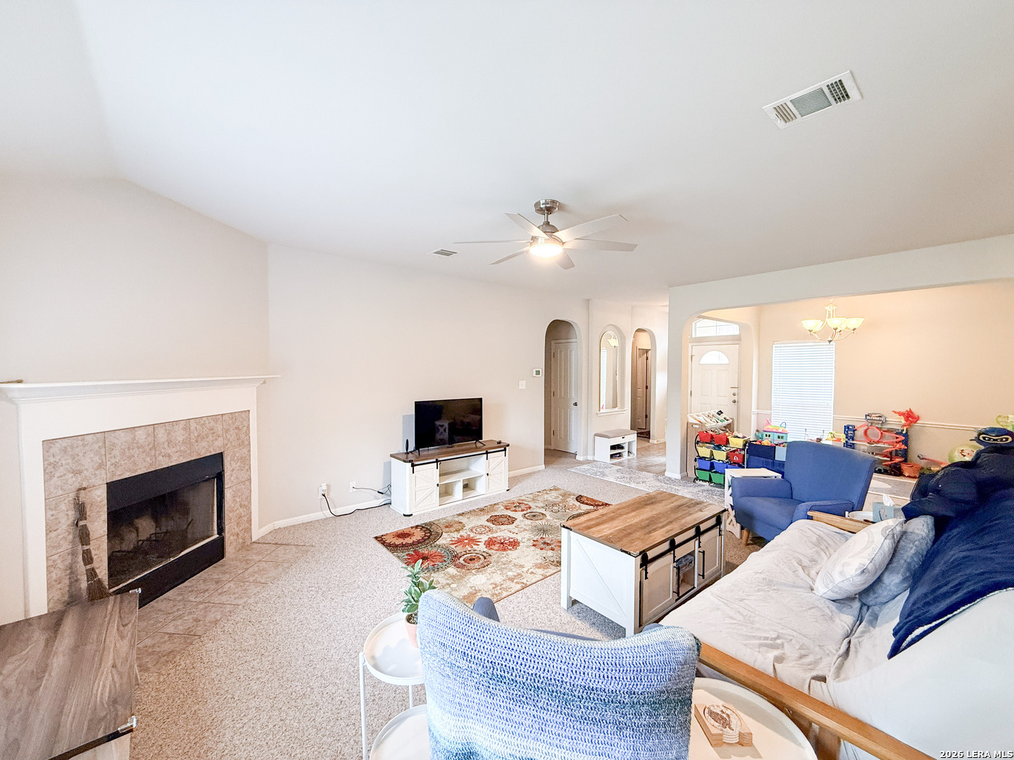 13715 Jubilee Way Helotes, TX 78023 - Photo 17 of 34 a living room with fireplace furniture and a fireplace
