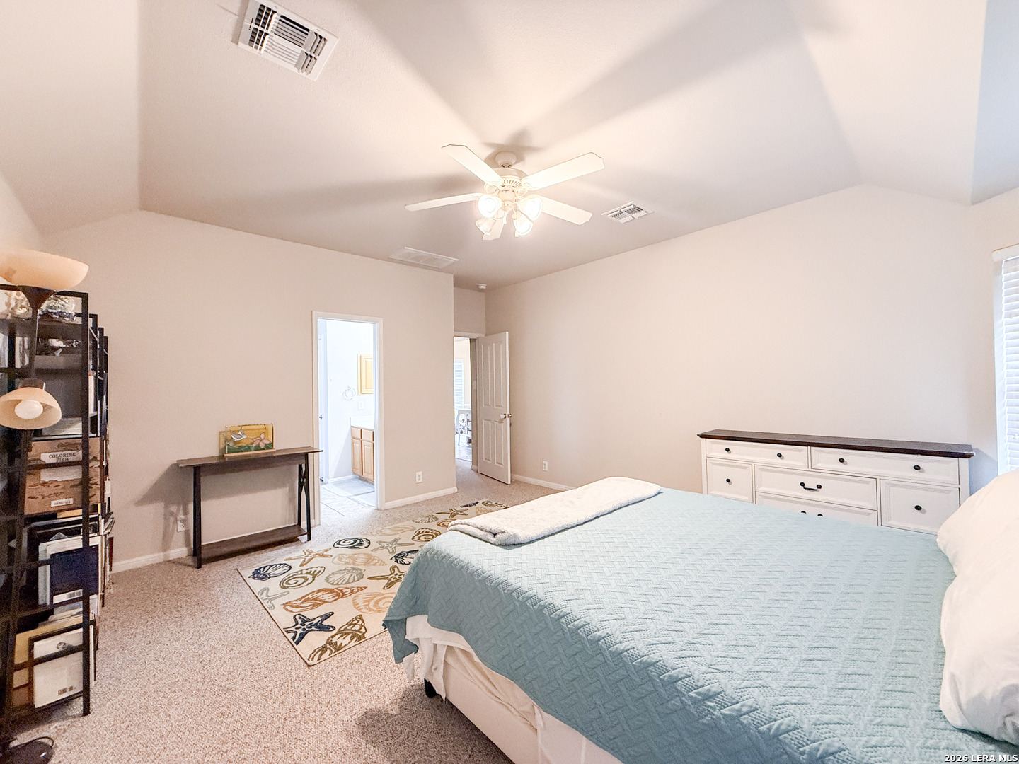 13715 Jubilee Way Helotes, TX 78023 - Photo 19 of 34 a bedroom with a bed and a chandelier