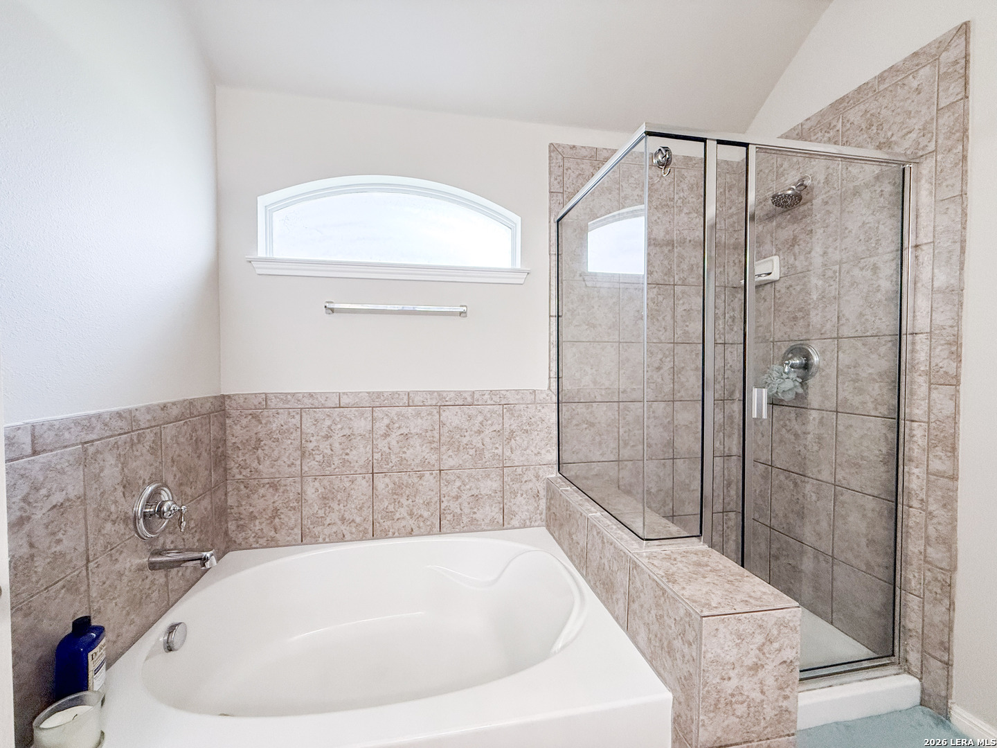 13715 Jubilee Way Helotes, TX 78023 - Photo 20 of 34 a bathroom with a bathtub and shower