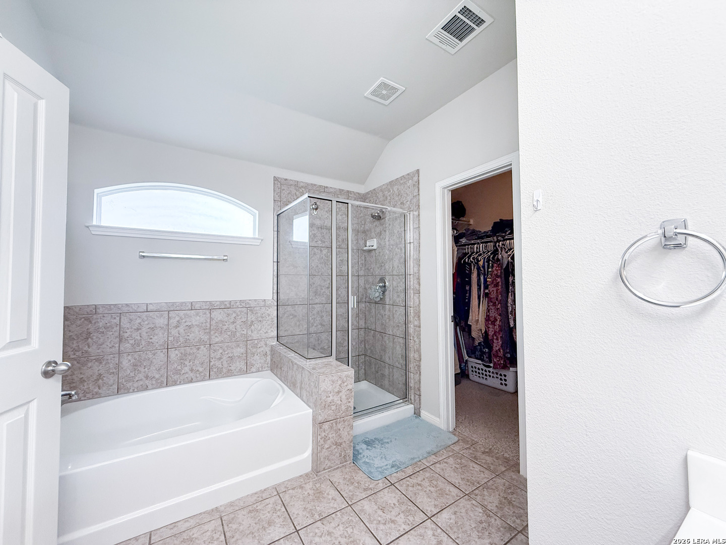 13715 Jubilee Way Helotes, TX 78023 - Photo 22 of 34 a bathroom with a bathtub and a shower