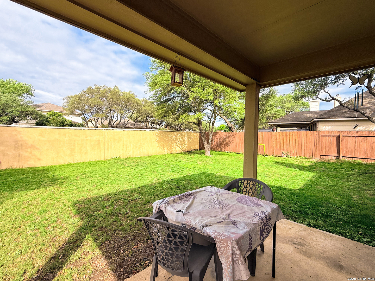 13715 Jubilee Way Helotes, TX 78023 - Photo 30 of 34 a view of a patio with lawn chairs floor to ceiling window next to a yard