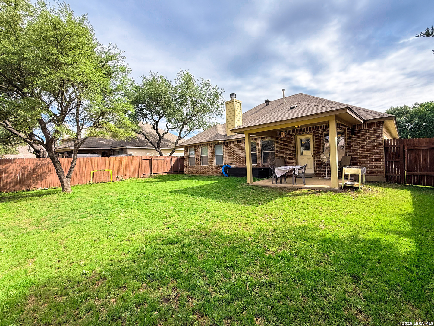 13715 Jubilee Way Helotes, TX 78023 - Photo 32 of 34 a view of a house with backyard and porch