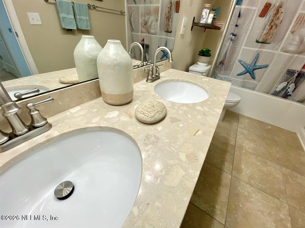 115 Sierras Loop St. Augustine, FL 32086 - Photo 43 of 65 a bathroom with a granite countertop sink