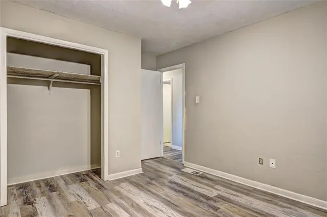 a view of a room with a window and wooden floor