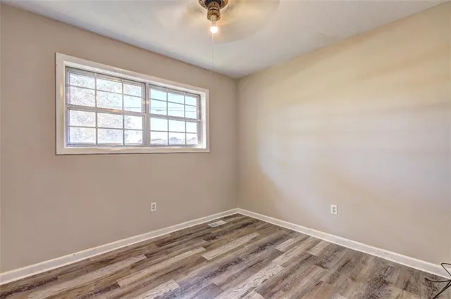 a view of an empty room with wooden floor
