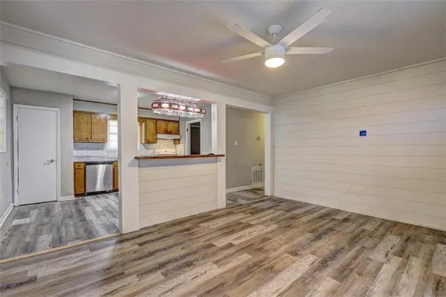 a view of a livingroom with wooden floor and a ceiling fan