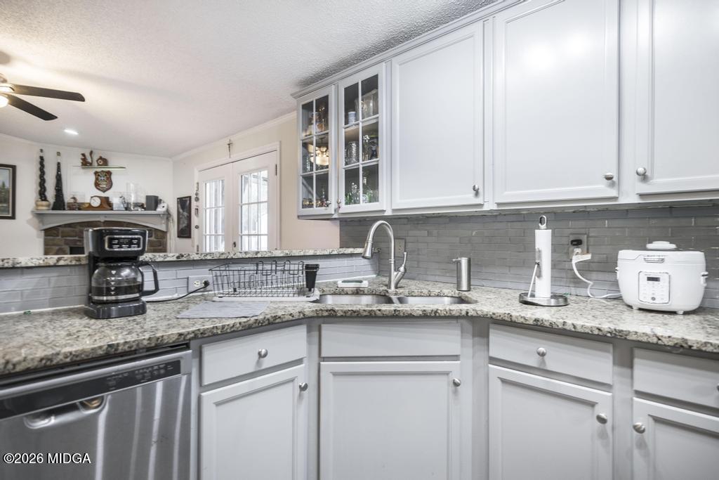 319 Pope Road Roberta, GA 31078 - Photo 13 of 42 a kitchen with granite countertop a sink stainless steel appliances and cabinets