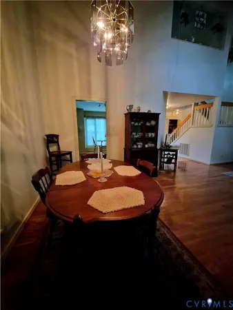 a living room with furniture and a refrigerator