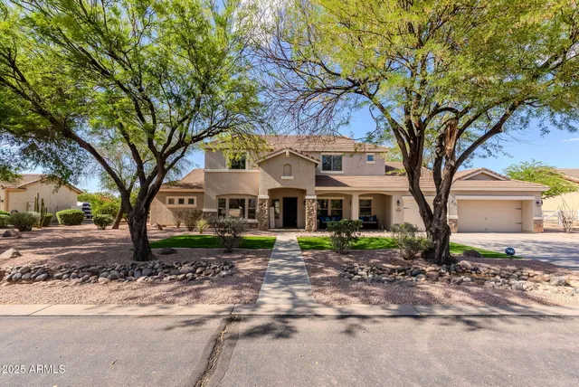 a front view of a house with a garden