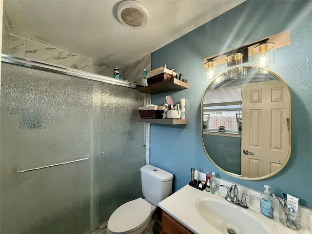 a bathroom with a toilet sink and mirror