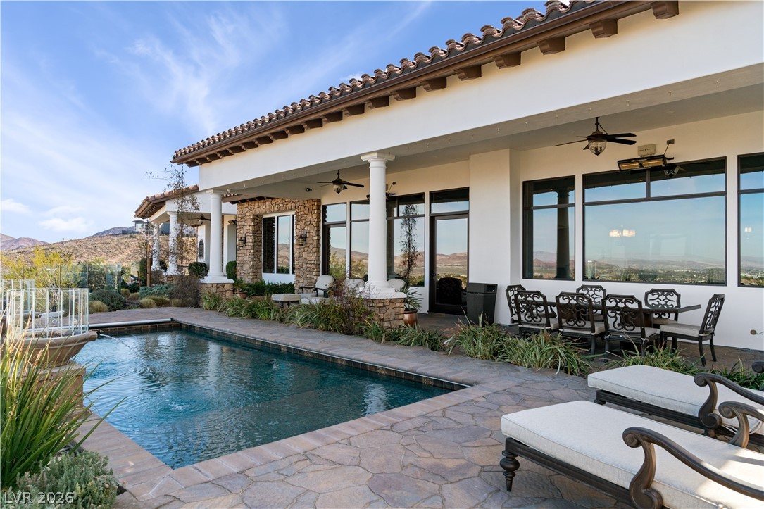1123 Christian Road Henderson, NV 89002 - Photo 58 of 94 An inviting backyard oasis offers a sparkling pool with a mountain backdrop and a spacious covered patio.