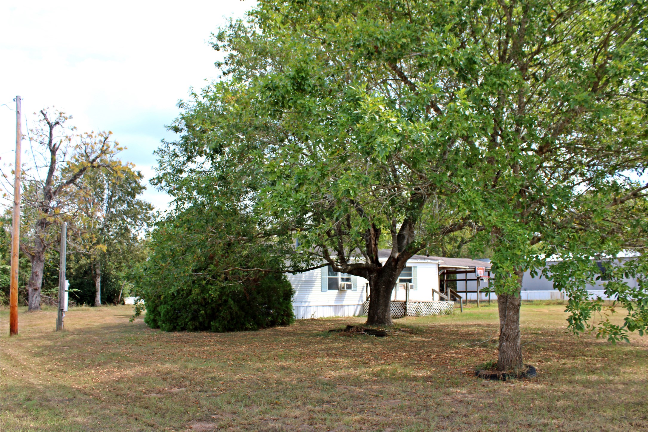 601 Travis Street Alleyton, TX 78935 - Photo 13 of 17 a front view of a house with a tree