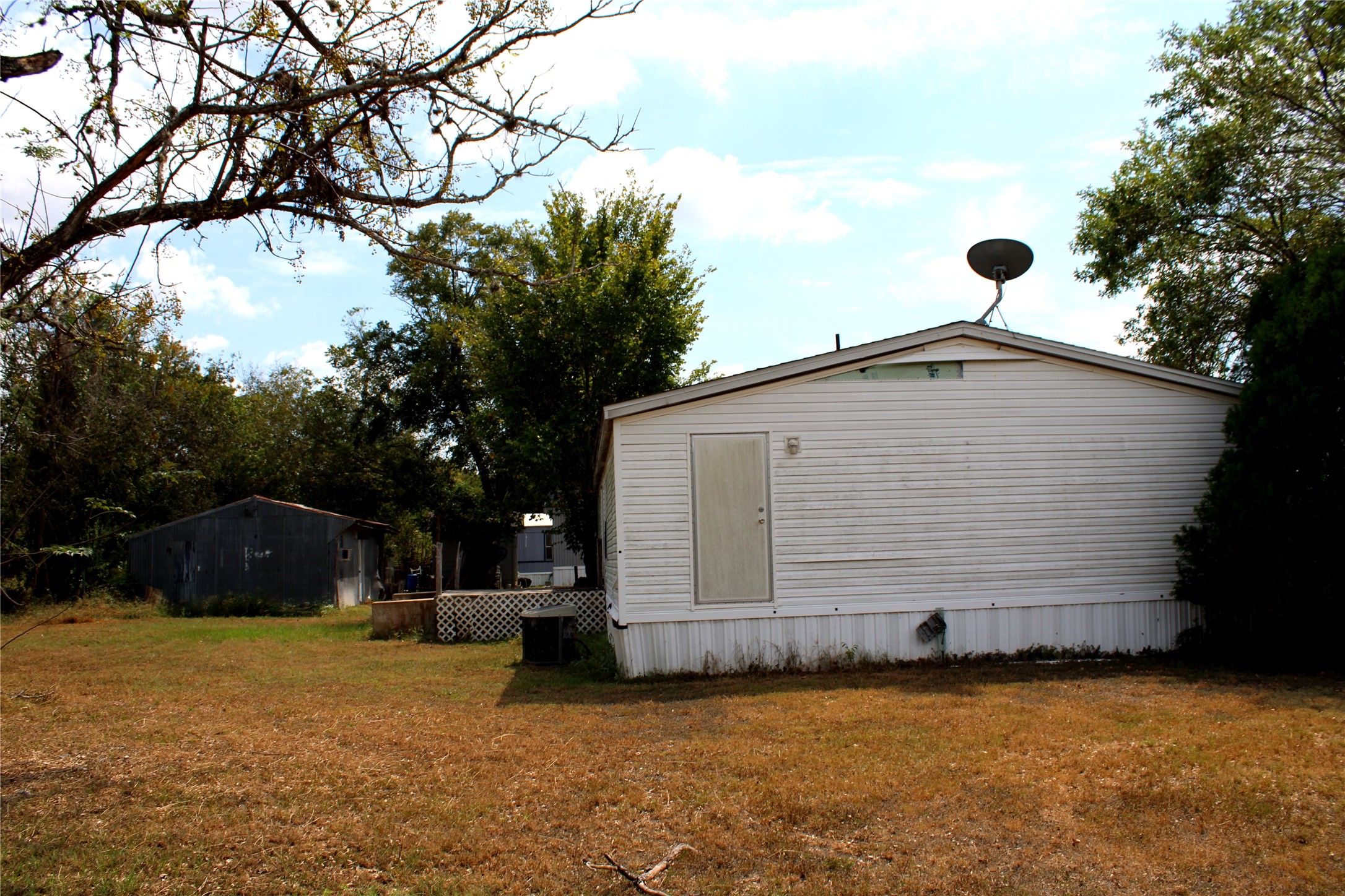 601 Travis Street Alleyton, TX 78935 - Photo 16 of 17 a view of a house with backyard and trees