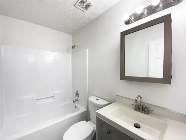 a bathroom with a toilet a sink and a bathtub