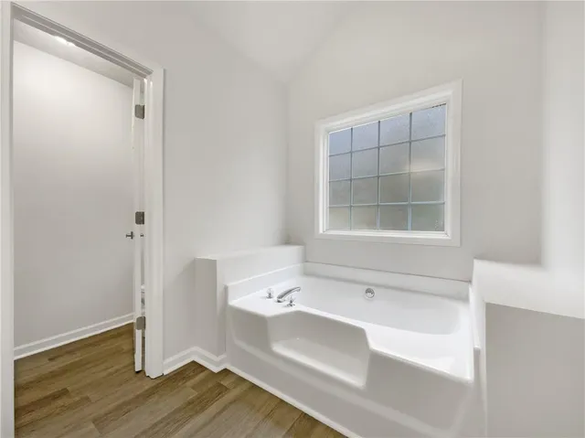 a bathroom with a tub shower and sink