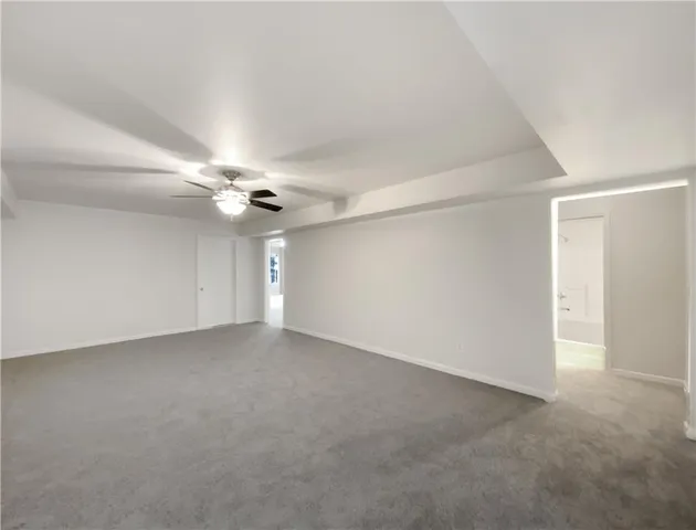 a view of an empty room with a ceiling fan