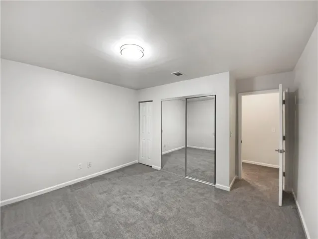 an empty room with closet area