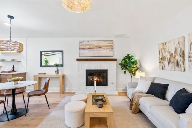 a living room with furniture a dining table and a fireplace
