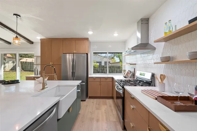 a large kitchen with a table and chairs in it