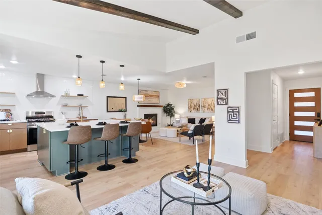 a living room with furniture and kitchen view