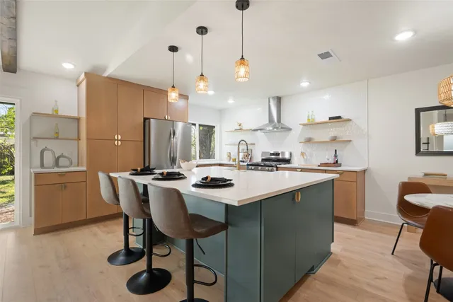 a kitchen with a sink stove and refrigerator