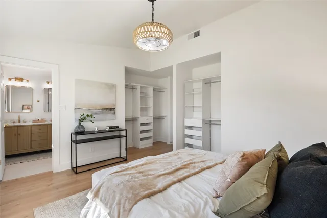 a bedroom with a bed and wooden floor