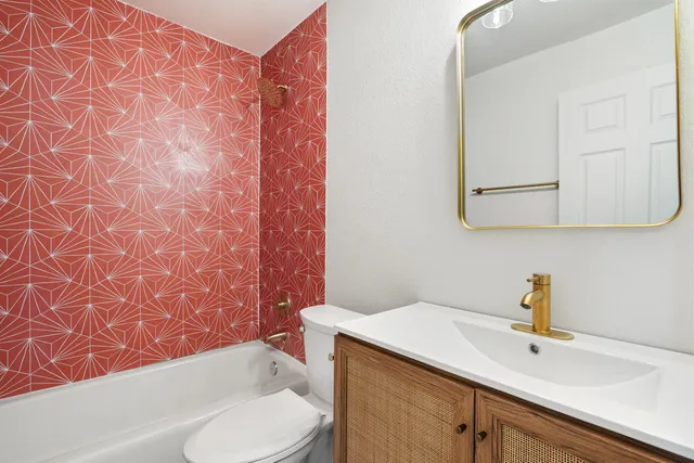 a bathroom with a double vanity sink toilet and shower