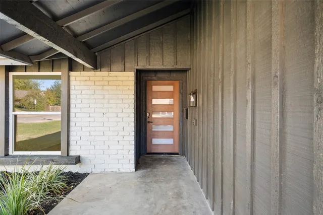 a view of a house with big yard and potted plants