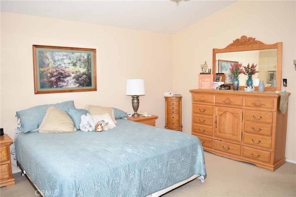 1665 Ravenswood Road Beaumont, CA 92223 - Photo 26 of 41 a bedroom with a bed and a painting on the wall