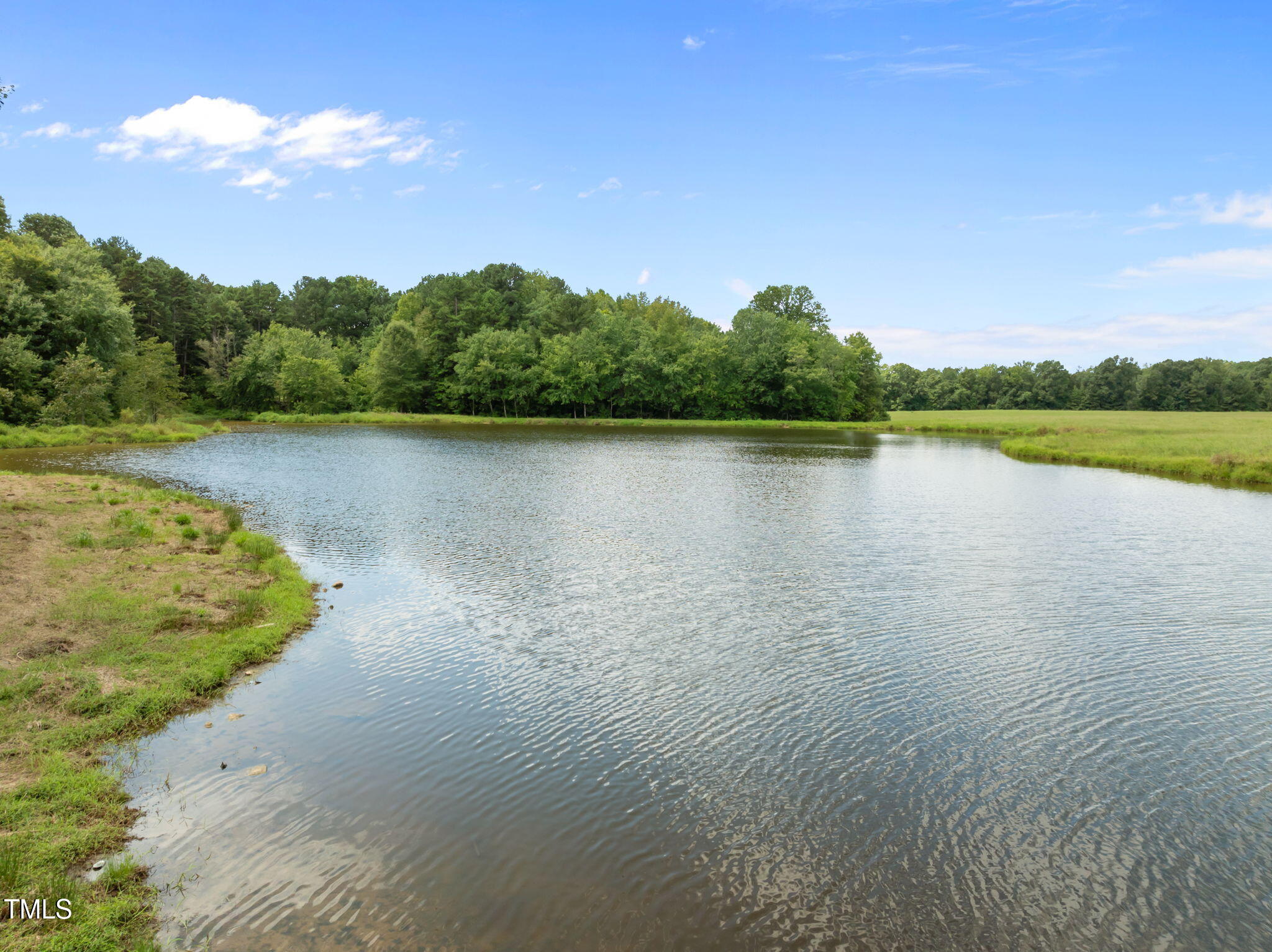 4715 Uzzle Road Rougemont, NC 27572 - Photo 56 of 68 a view of a lake with houses in the back