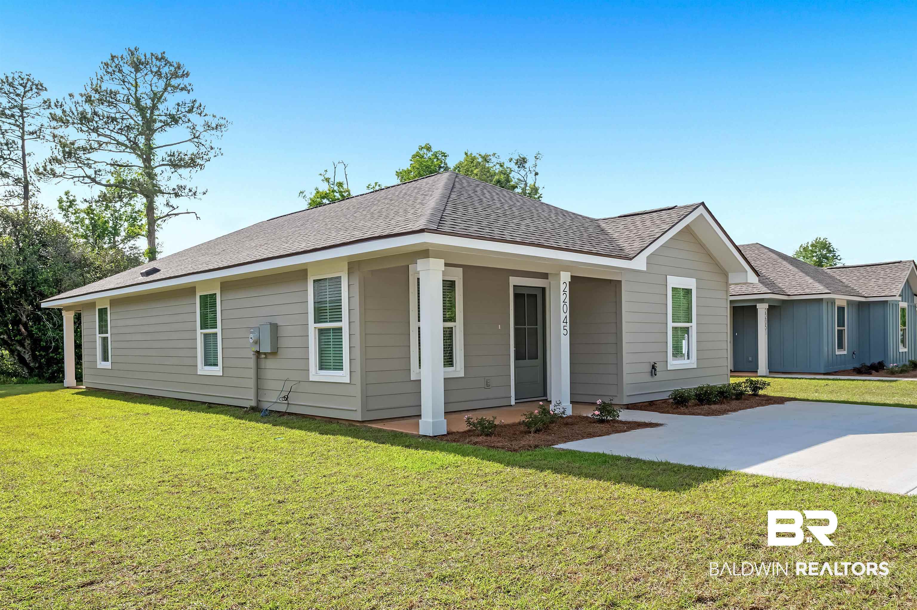 22045 8th Street Silverhill, AL 36576 - Photo 2 of 39 Single story home with a front lawn, roof with shingles, and covered porch