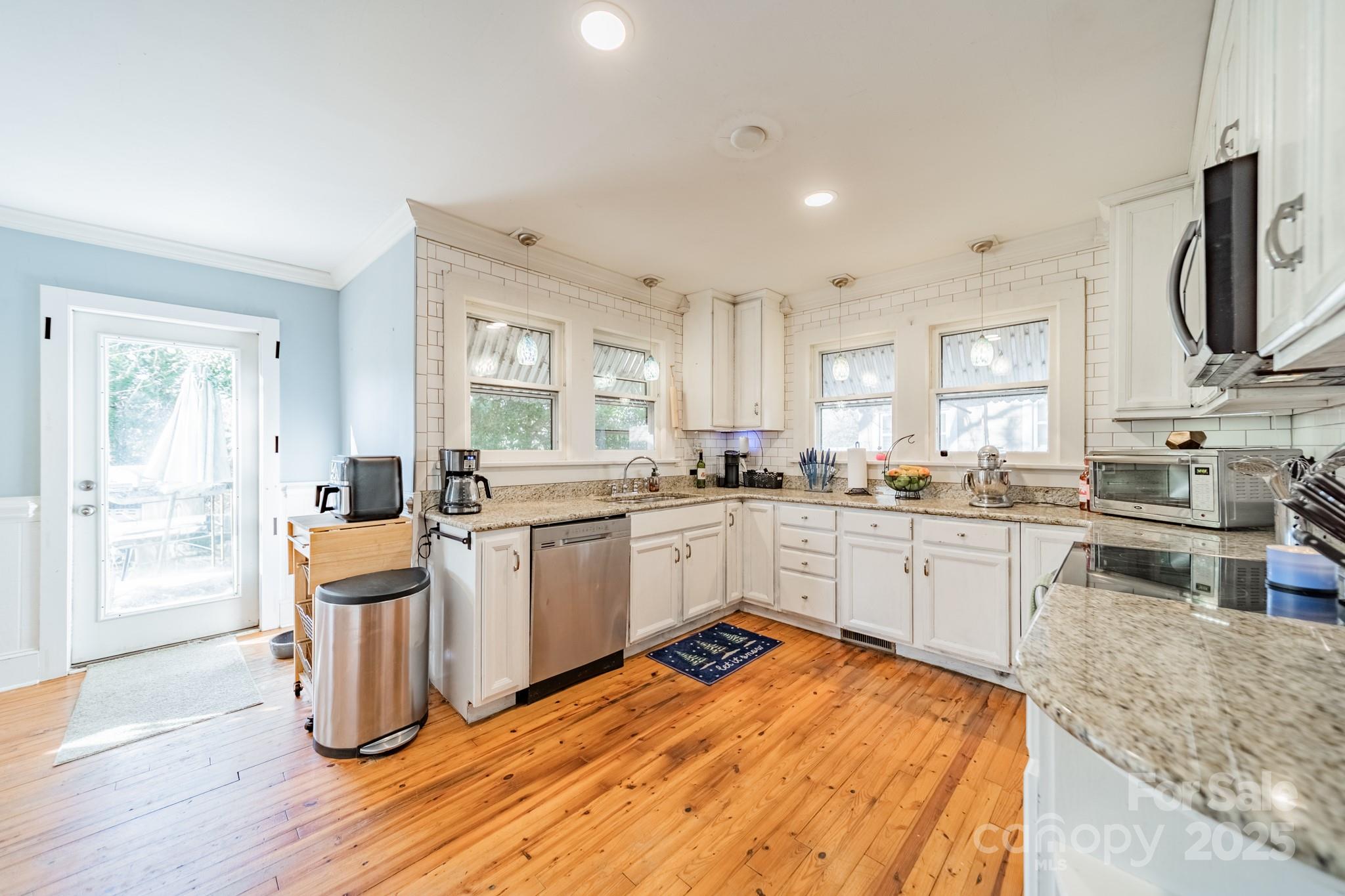 503 4th Street Spencer, NC 28159 - Photo 10 of 30 a kitchen with wooden floors and white appliances