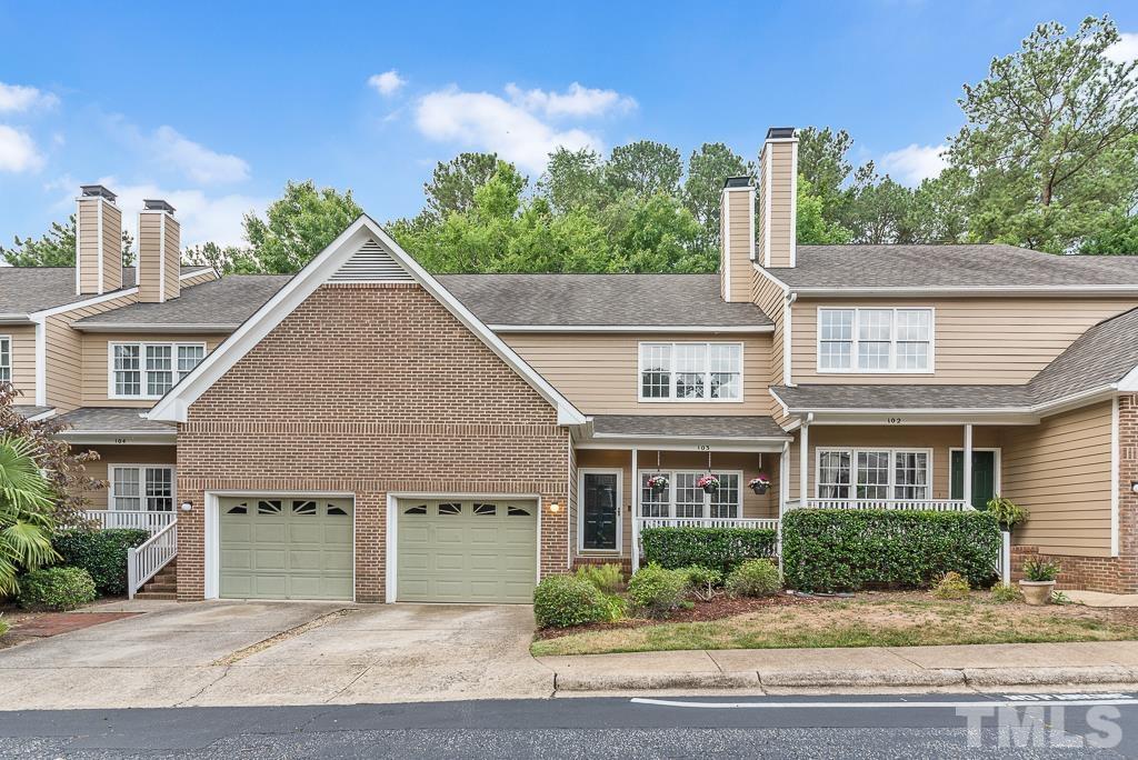 7030 Sandy Forks Road, Unit 103 Raleigh, NC 27615 - Photo 1 of 36 a view of a yard in front of a brick house