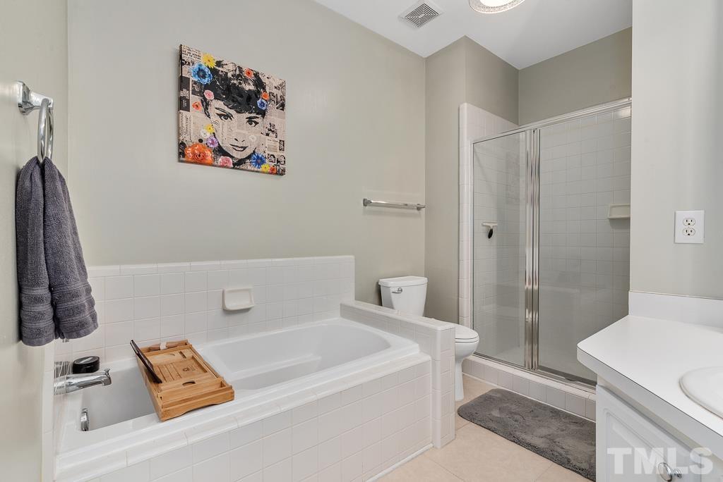 7030 Sandy Forks Road, Unit 103 Raleigh, NC 27615 - Photo 15 of 36 a bathroom with a tub and a shower