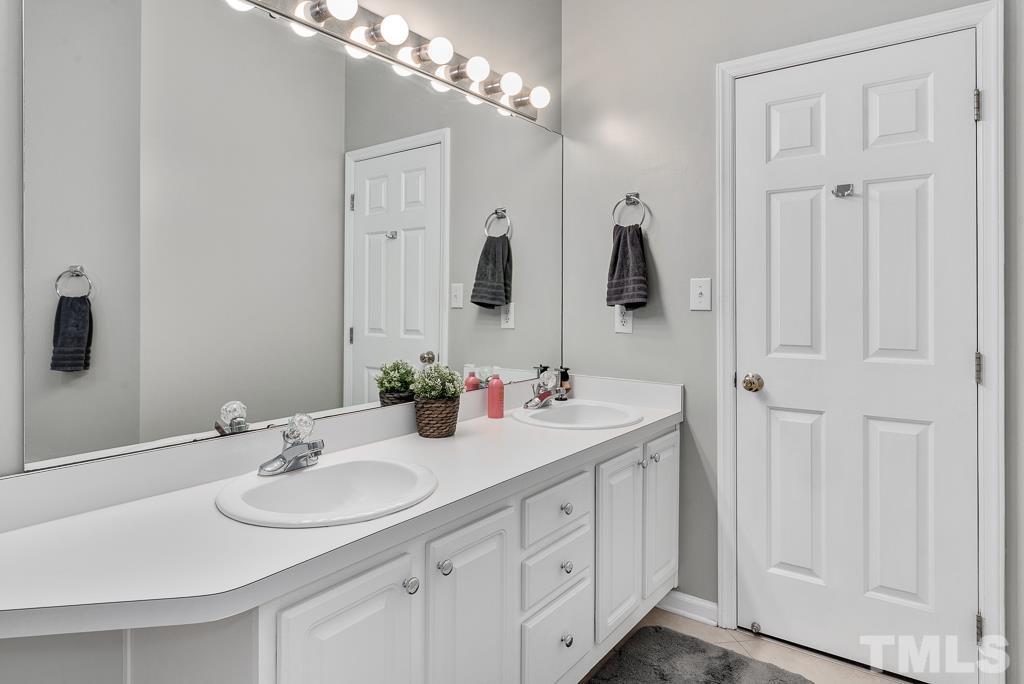 7030 Sandy Forks Road, Unit 103 Raleigh, NC 27615 - Photo 16 of 36 a bathroom with a sink and a mirror