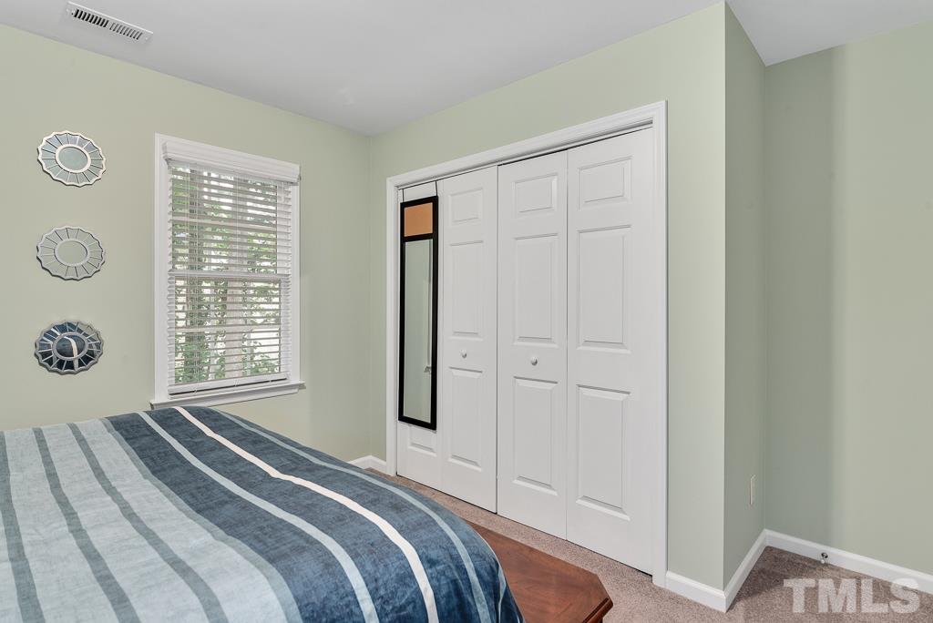 7030 Sandy Forks Road, Unit 103 Raleigh, NC 27615 - Photo 20 of 36 a bedroom with a bed and a window
