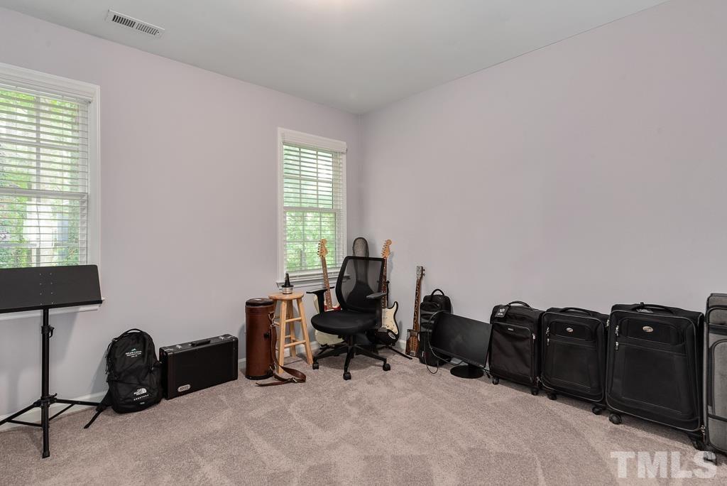 7030 Sandy Forks Road, Unit 103 Raleigh, NC 27615 - Photo 22 of 36 a view of a workspace with furniture and a window