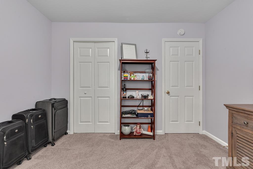 7030 Sandy Forks Road, Unit 103 Raleigh, NC 27615 - Photo 23 of 36 a view of an empty room with closet and mirror